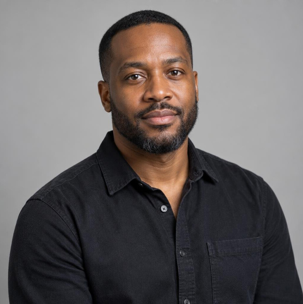 Portrait of a Black British man in his thirties with a short beard