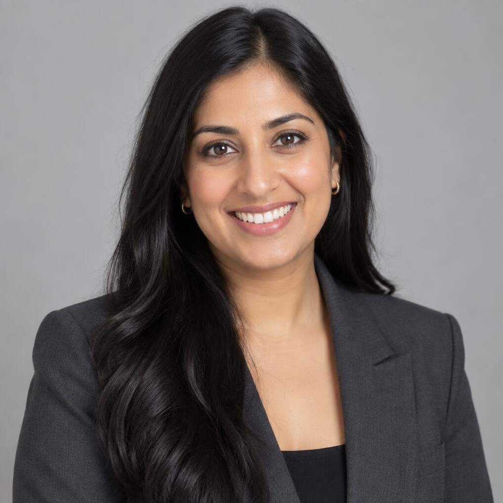 Portrait of a South Asian woman in her thirties in a dark blazer